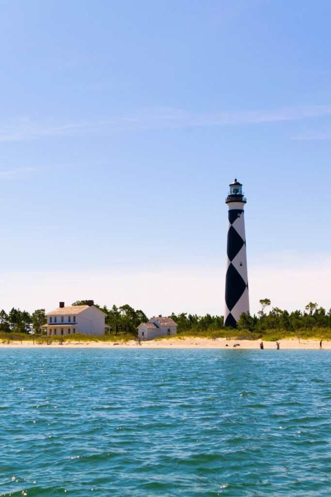 view of cape lookout lighthouse and keepers house as seen from the water