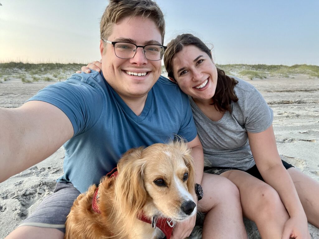 kate storm jeremy storm and ranger storm sitting on the sand at atlantic beach north carolina